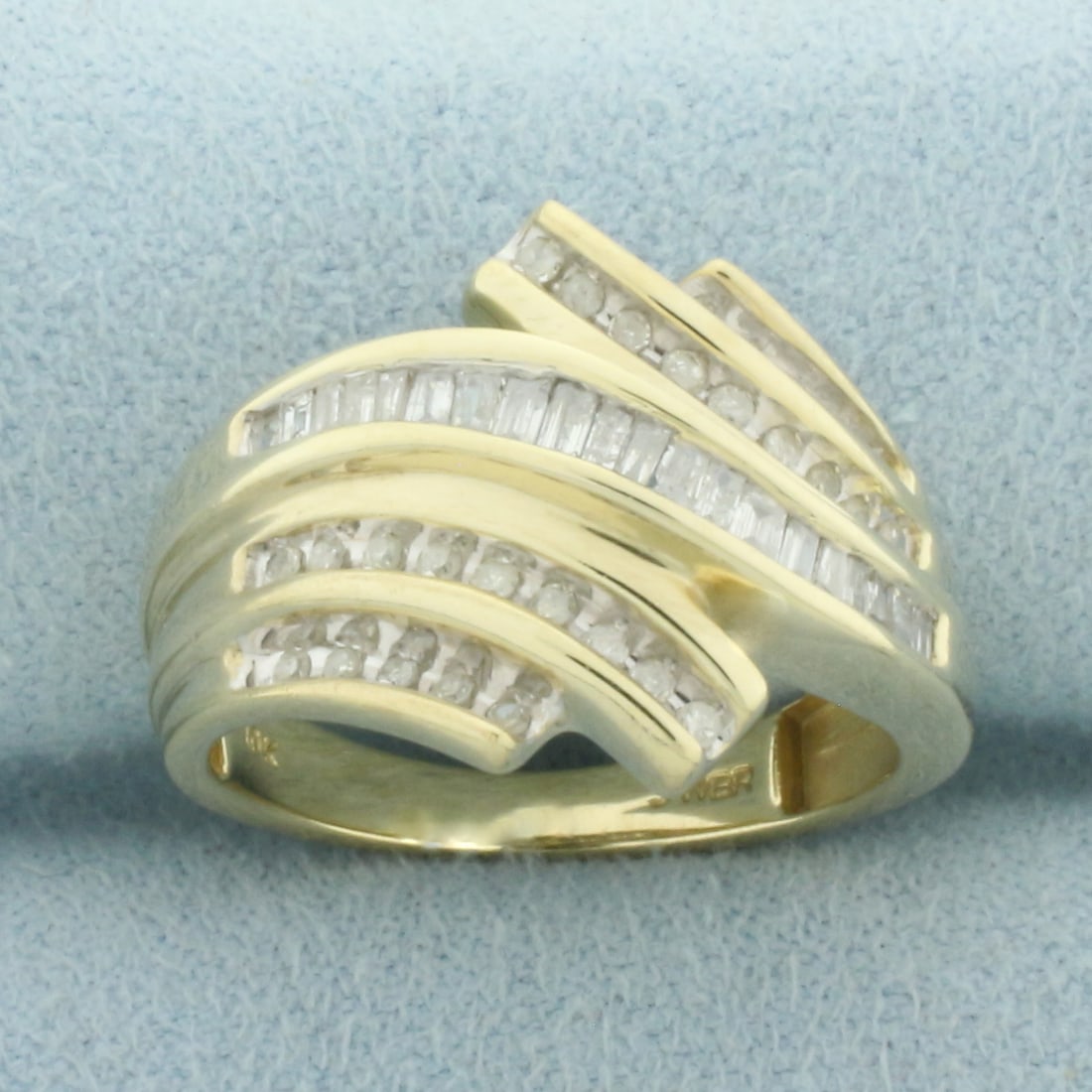 Baguette Diamond Ring in 10k Yellow Gold: In 10k Yellow Gold. Contains twenty-eight round and twenty baguette high quality diamonds, 1/2ct TW, I color/I clarity. 15.7mm wide at top of ring. Size 7. 3.8g.
