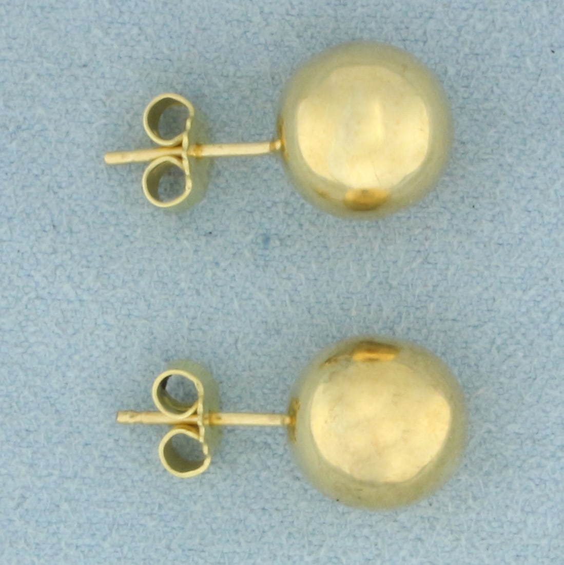10mm Ball Stud Earrings in 18k Yellow Gold: In 18k Yellow Gold. 10mm ball beads. Friction backs. 2.1g.