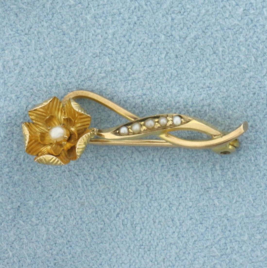 Antique Pearl Flower Brooch Pin in 14k Yellow Gold: In 14k Yellow Gold. Contains six high quality seed pearls with silver undertone and high luster. 1 inch long. 3/8 inch wide. .9g.