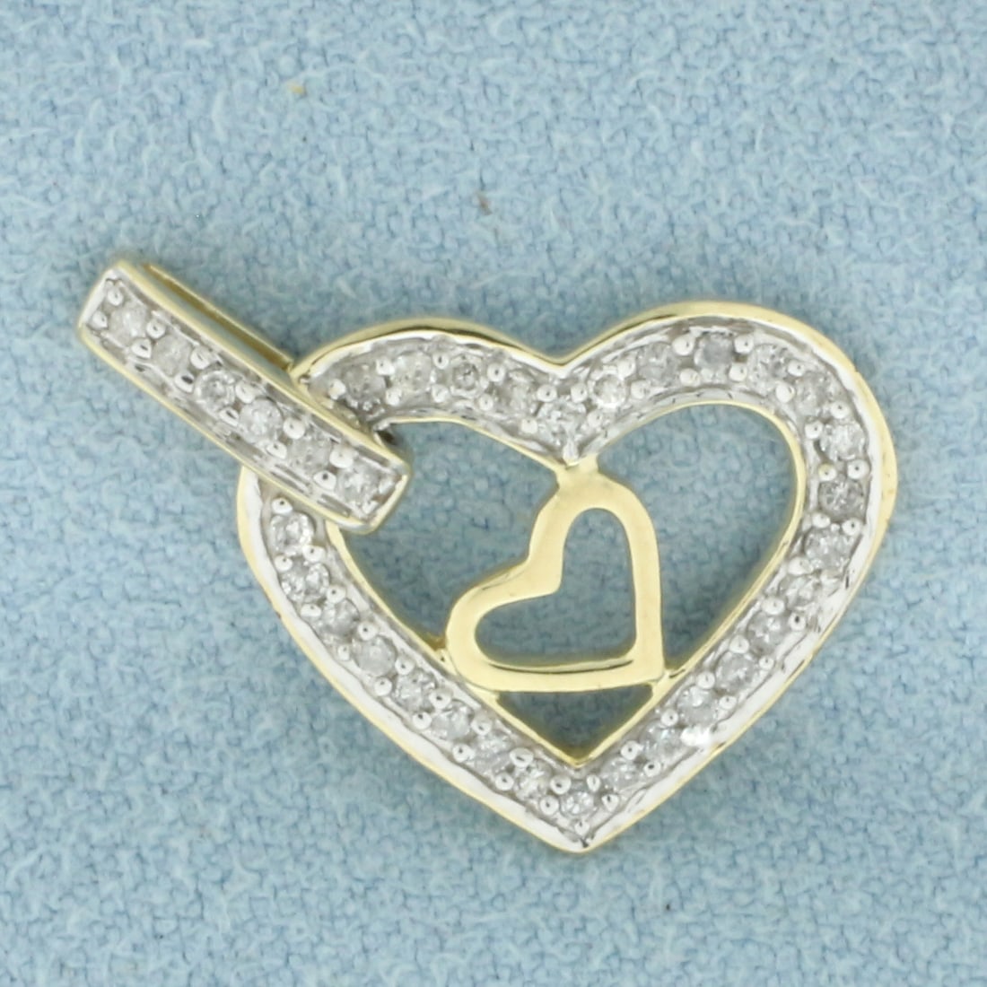 Double Heart Pendant in 10k Yellow Gold: In 10k Yellow Gold. Contains thirty-four high quality 1/2pt diamonds. 3/4 inch long. 1/2 inch wide. 1.4g.