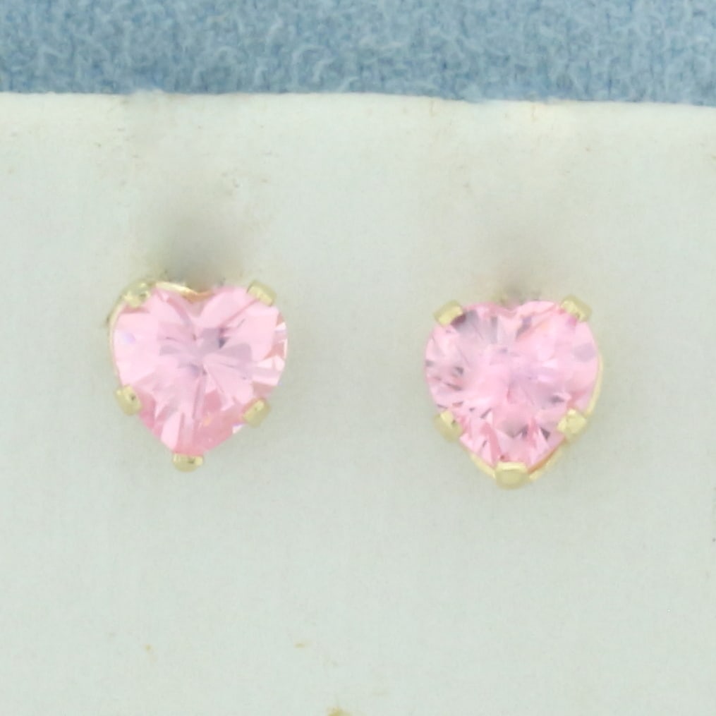 Heart Morganite Stud Earrings in 14k Yellow Gold: In 14k yellow gold. Contains two high quality natural 5mm heart shaped Morganite gemstones with bright color and excellent clarity. Friction backs. .8g.