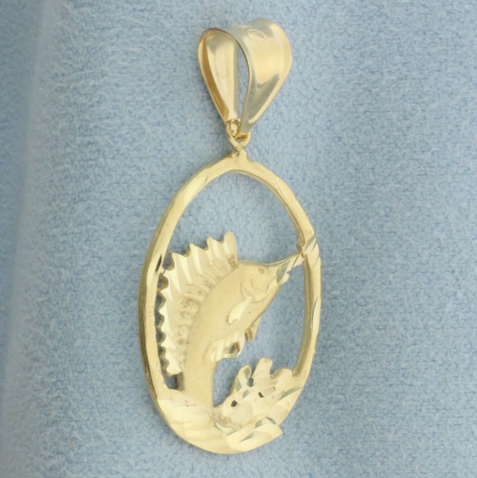 Sailfish Pendant in 14k Yellow Gold: In 14k yellow gold. 1 1/4 inches long and 5/8 inch wide. Diamond cut details. 2.0g.