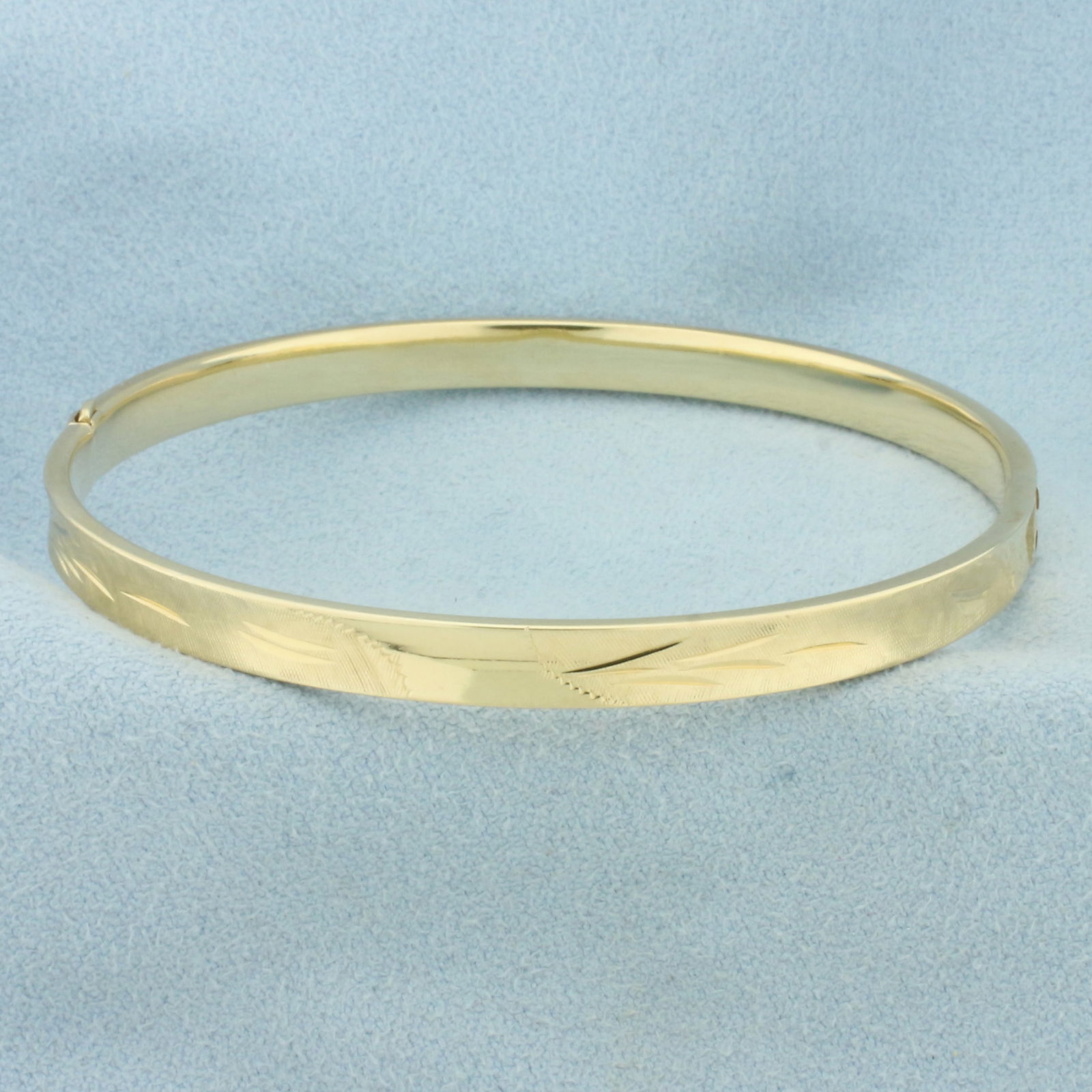 Etched Nature Design Bangle Bracelet in 14k Yellow Gold: In 14k Yellow Gold. Interior dimension: 2 1/4 by 2 1/4 inches. 4.7mm wide. Slide bar closure. Easily opens/closes for easy putting on/taking off. 5.8g.