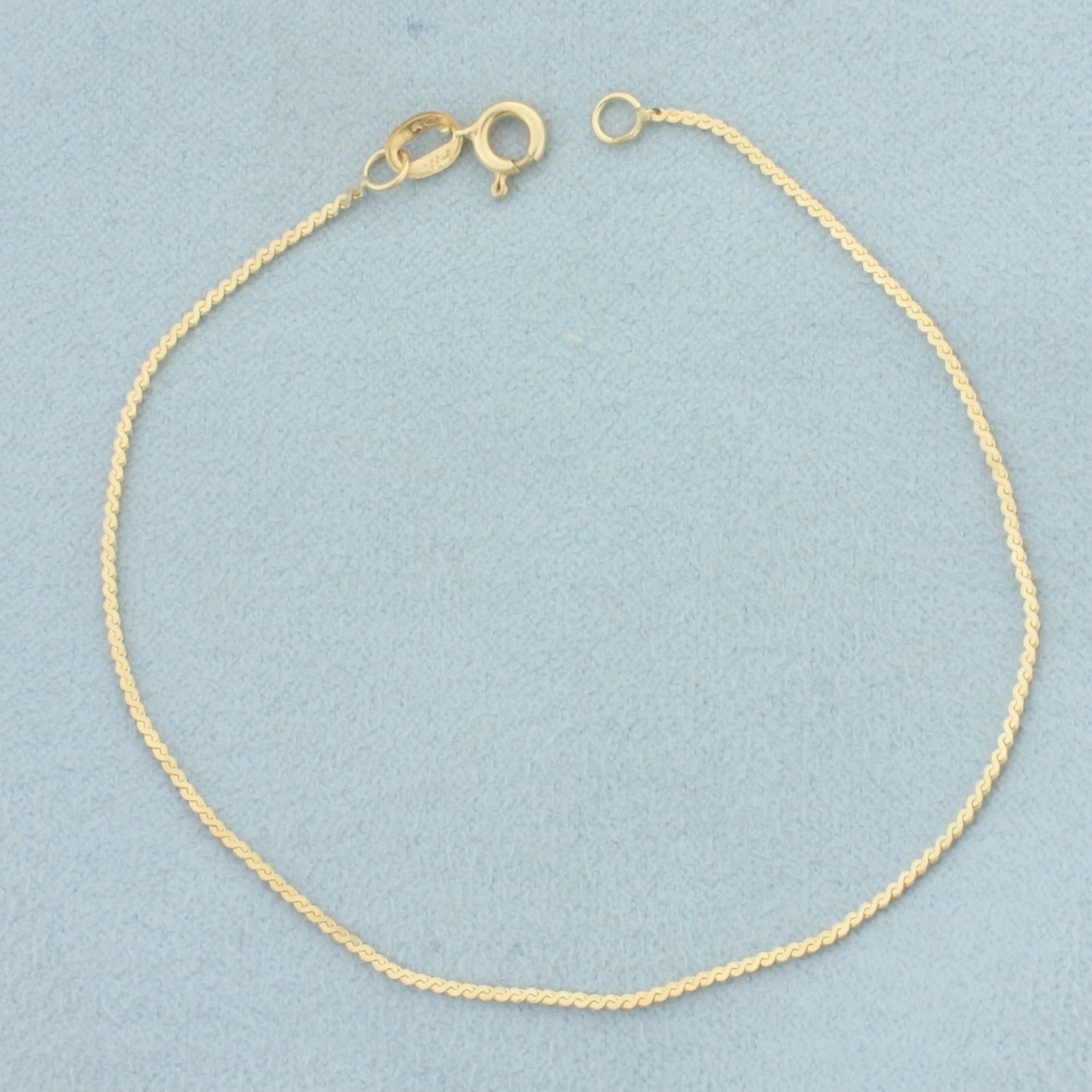 Serpentine S Link Bracelet in 14k Yellow Gold: In 14k Yellow Gold. 7 1/8 inches long. 1mm wide. Spring clasp. .8g.