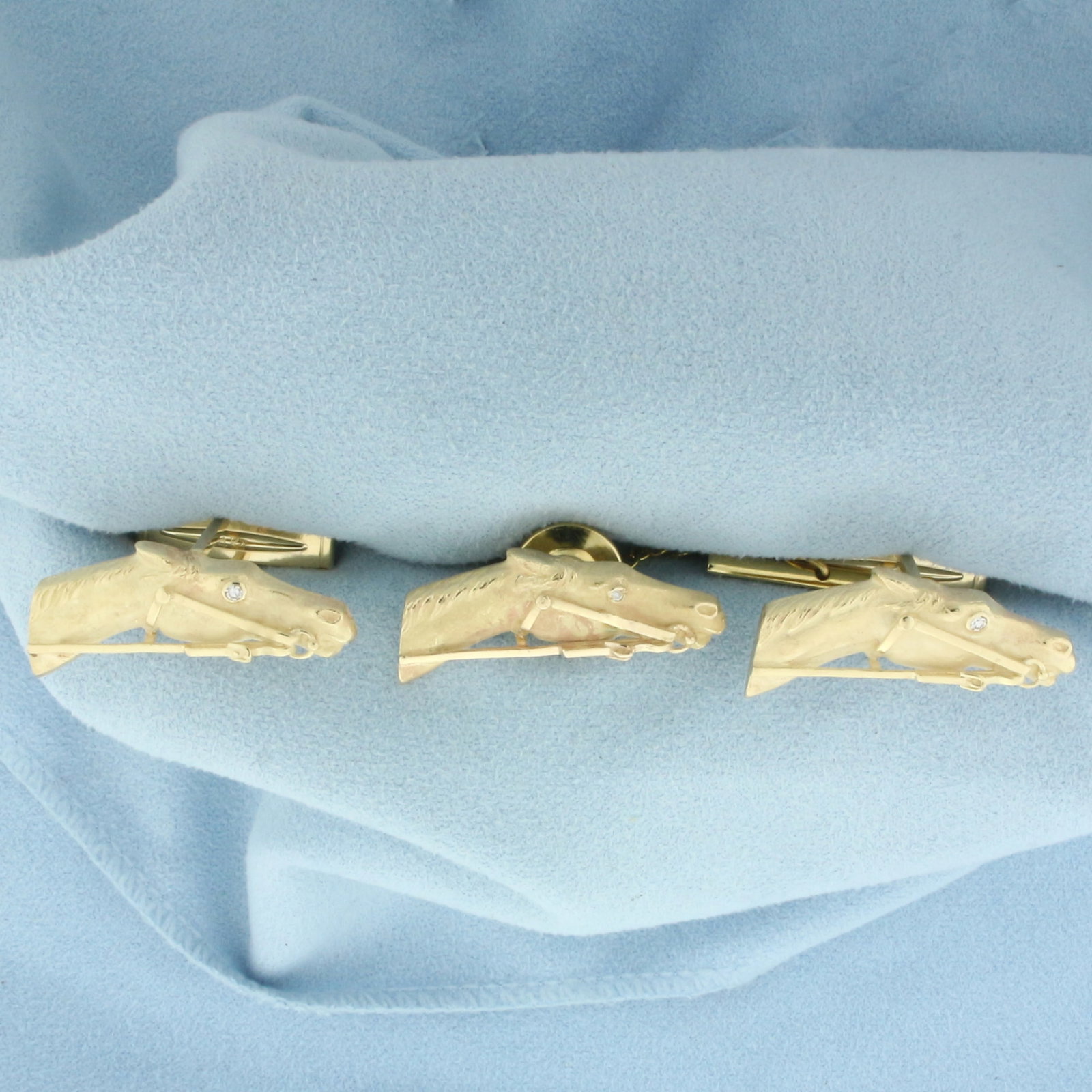 Horse Racing Diamond Cufflinks and Tie Tack Pin Set in 14k Yellow Gold: In 14k yellow gold. Contains three high quality .02ct diamonds, VS clarity/G color. Horse heads measure 1 1/8 inches wide by 1/2 inches high. 24.1g.