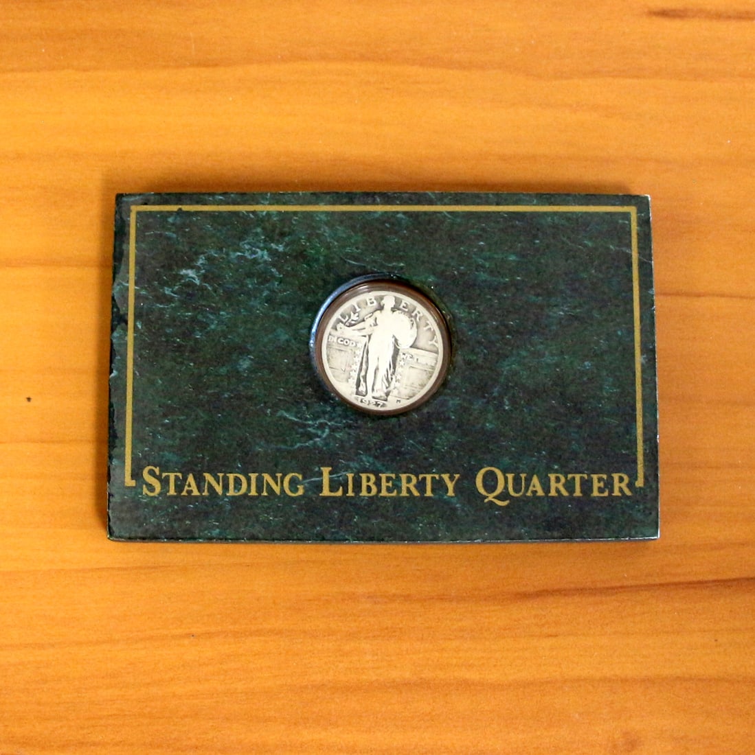 1927 US Mint Standing Liberty Quarter In Case: Contains one 1927 Standing Liberty Quarter. Set in block casing.