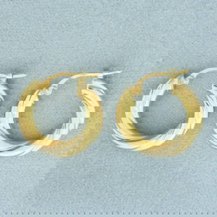 Two Tone Twisting Hoop Earrings in 18k Yellow and White Gold: In 18k Yellow and White Gold. 5/8 inch long. 3.4mm thick. Leverback. 1.7g.