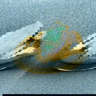 Australian Opal and Diamond Ring in 14k Yellow Gold: In 14k Yellow Gold. Contains one high quality natural 12mm Australian Opal with very intense play of color, flashes of purple, green, red, and orange. Does have very think crack. Also contains one .02