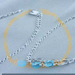 Swiss Blue Topaz and Diamond Figaro Bracelet in 14k Yellow Gold: In 14k Yellow Gold. Contains three high quality natural 8mmx6mm Swiss Blue Topaz gemstones, 4.5ct TW, with electric blue color and excellent clarity. Also contains eight .02ct diamonds, SI clarity/H c