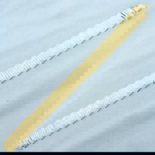 Italian Omega Link Bracelet in 14K Yellow Gold: in 14K Yellow Gold. Safety clasp. 7 1/4 inches long. 14.8mm wide. Alternate links are diamond cut for unique look. 23.4g