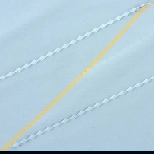 Italian Diamond Cut Striped Design Omega Bracelet in 14k Yellow Gold: In 14k yellow gold. 7 1/8 inches long and 4mm wide. Sparkle diamond cut finish with diagonal stripe design. Concealed slide clasp with safety latch. 9.5g.