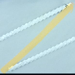 Italian Diamond Cut Striped Wide Omega Bracelet in 14k Yellow Gold: In 14k Yellow Gold. 7 1/8 inches long. 1/2 inch wide. Italian made. Concealed slide clasp with safety latch. 20.8g.