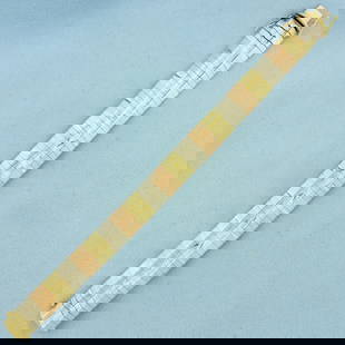 Tri Color Diamond Cut Omega Bracelet in 14k Yellow, Rose, and White Gold: In 14k Yellow, Rose, and White Gold. Italian made. 7 1/4 inches long, 12.3mm wide. Concealed side closure with 2 safety latches. Diamond cut design. 25.8g.