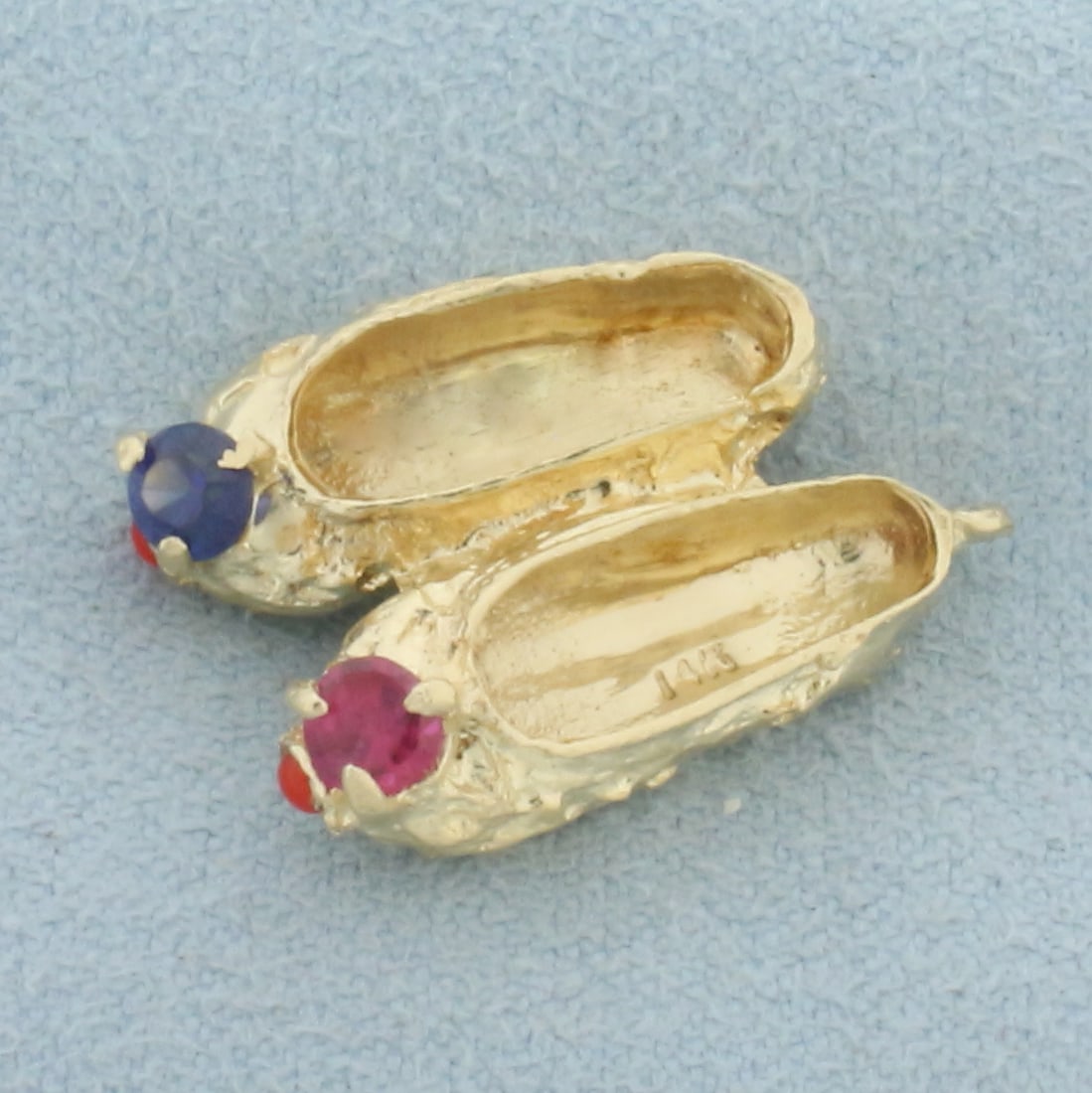 Ruby and Sapphire Ballet Slippers Charm or Pendant in 14k Yellow Gold: In 14k yellow gold. Contains one high quality natural 3.5mm Sapphire and Ruby gemstones with intense color and excellent clarity . 7/8 inches long by 1/2 inches wide. 4.0g