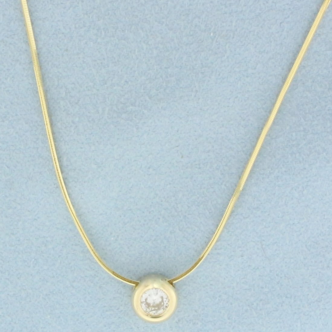 17 Inch Diamond Solitaire Snake Link Necklace in 14k Yellow Gold: In 14k yellow gold. Contains one high quality 1/2ct round brilliant diamond, SI clarity/H color, great cut for lots of sparkle. 17 inch long, .7mm thick snake link chain. Spring clasp. 3.4g.