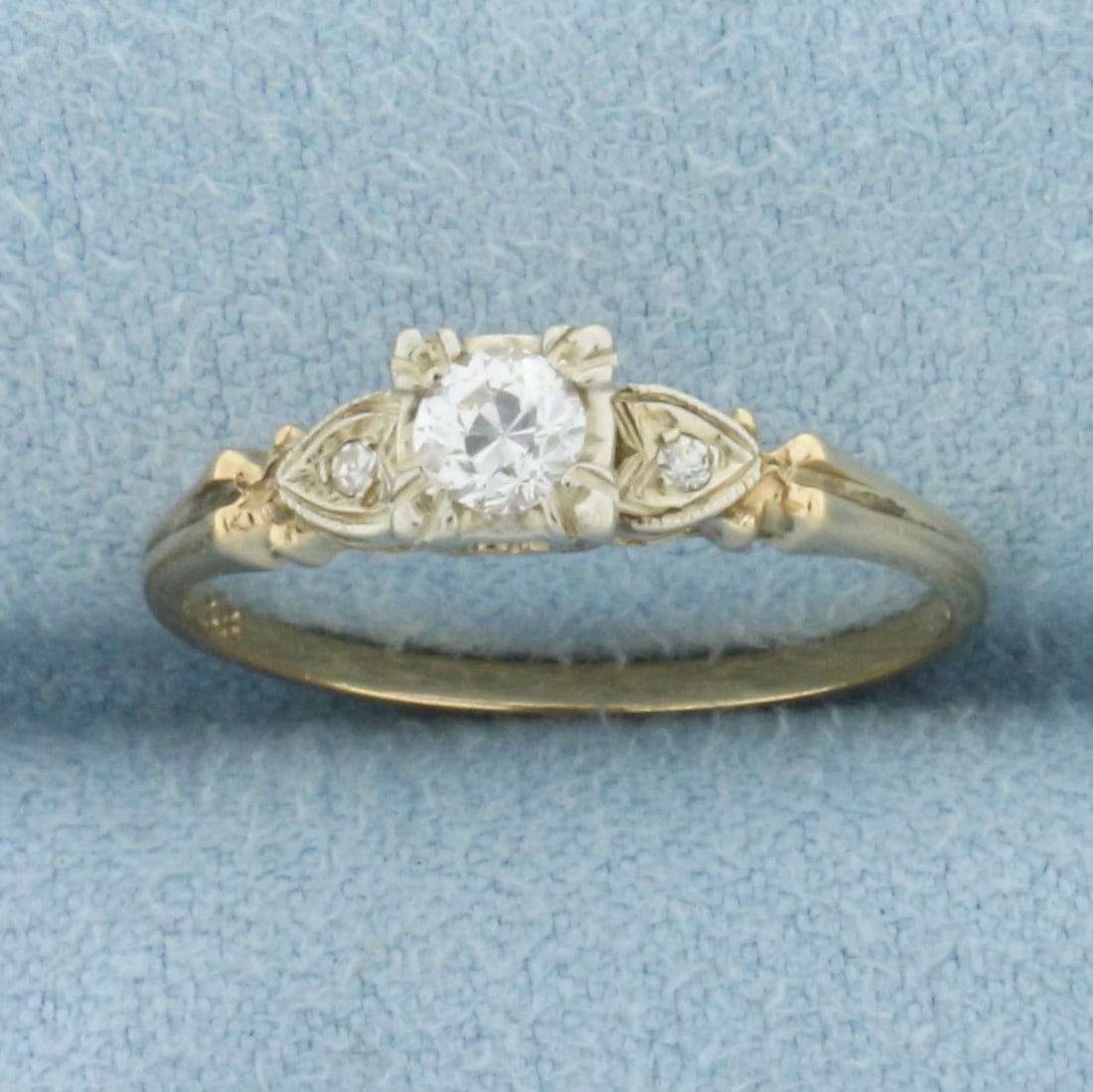Antique Old European Diamond Engagement Ring in 14k Yellow Gold: In 14k Yellow Gold. Contains one high quality 1/5ct old European diamond, SI1 clarity/H color. Also contains two .01ct diamonds of similar high quality. Milgrain and heart detail. Size 6. 1.5g.