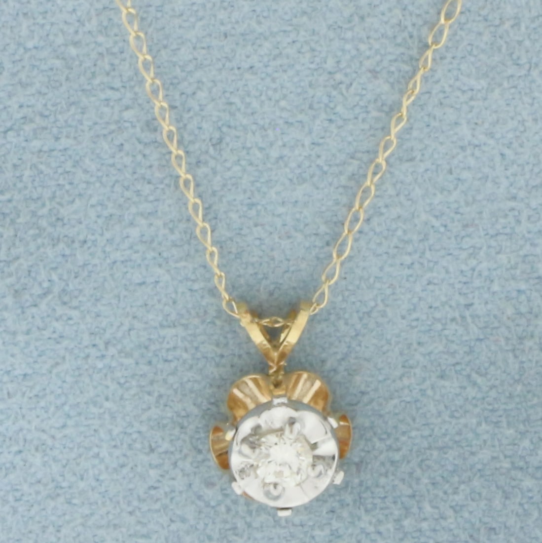 Diamond Solitaire Necklace in 14k Yellow Gold: In 14k Yellow Gold. Contains one 1/10ct high quality diamond, VS clarity/G color. Set in reflective mounting to look like much larger 3/4ct diamond. 3/8 inch long by 1/4 inch wide pendant. 16 inch lon