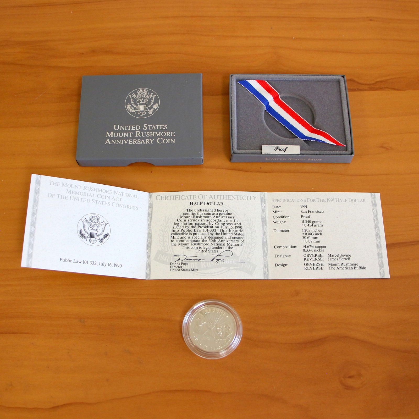 1991 US Mint Mount Rushmore Half Dollar Proof Coin OGP: Contains one 1991 U.S. Mount Rushmore Anniversary Half Dollar Proof Coin. Includes CoA, original packaging and casing.