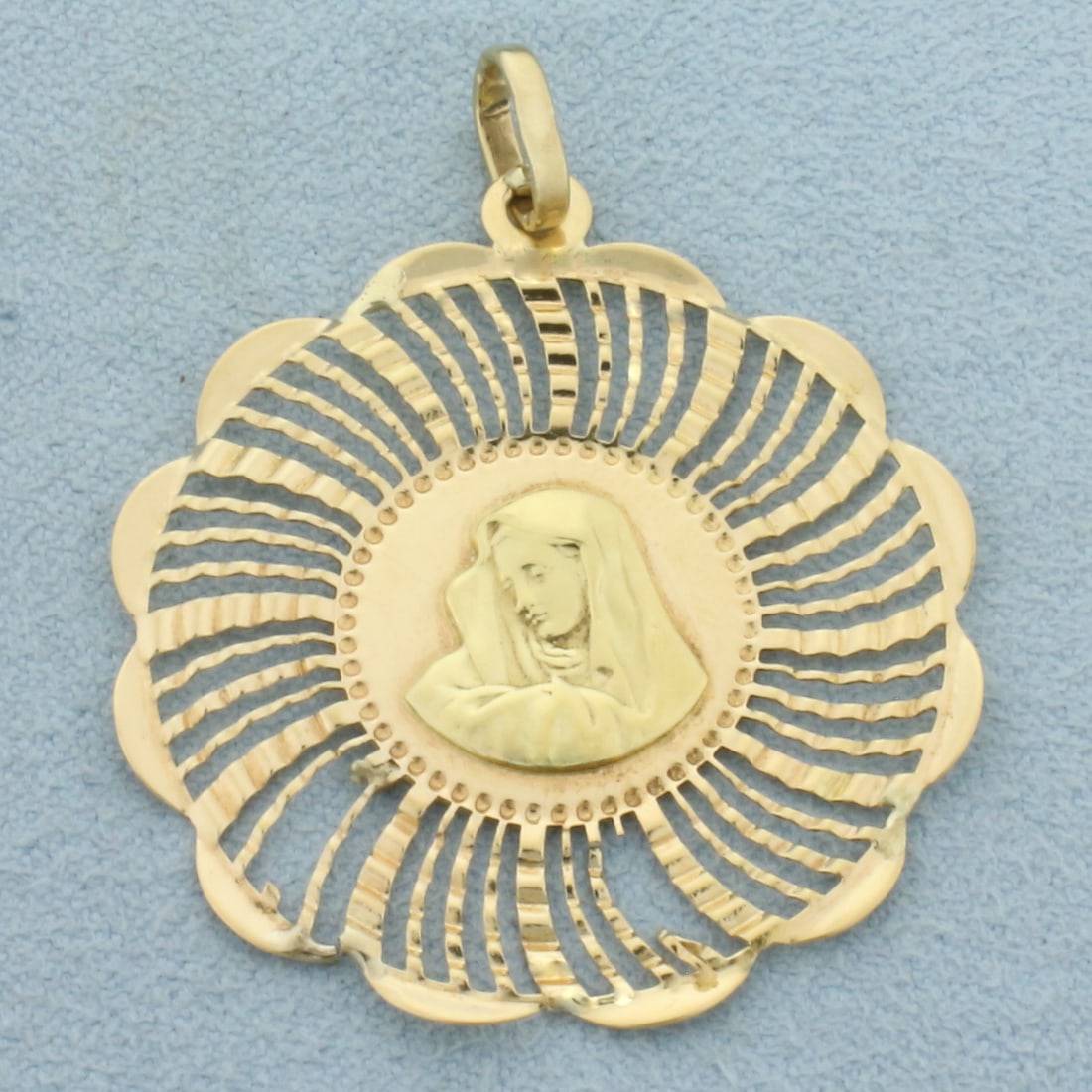 Vintage Virgin Mary Pendant in 18k Yellow Gold: In 18k Yellow Gold. 1 1/2 inches long. 1 1/4 inches wide. Two minor defects in the spokes, indicative of age. 2.9g.