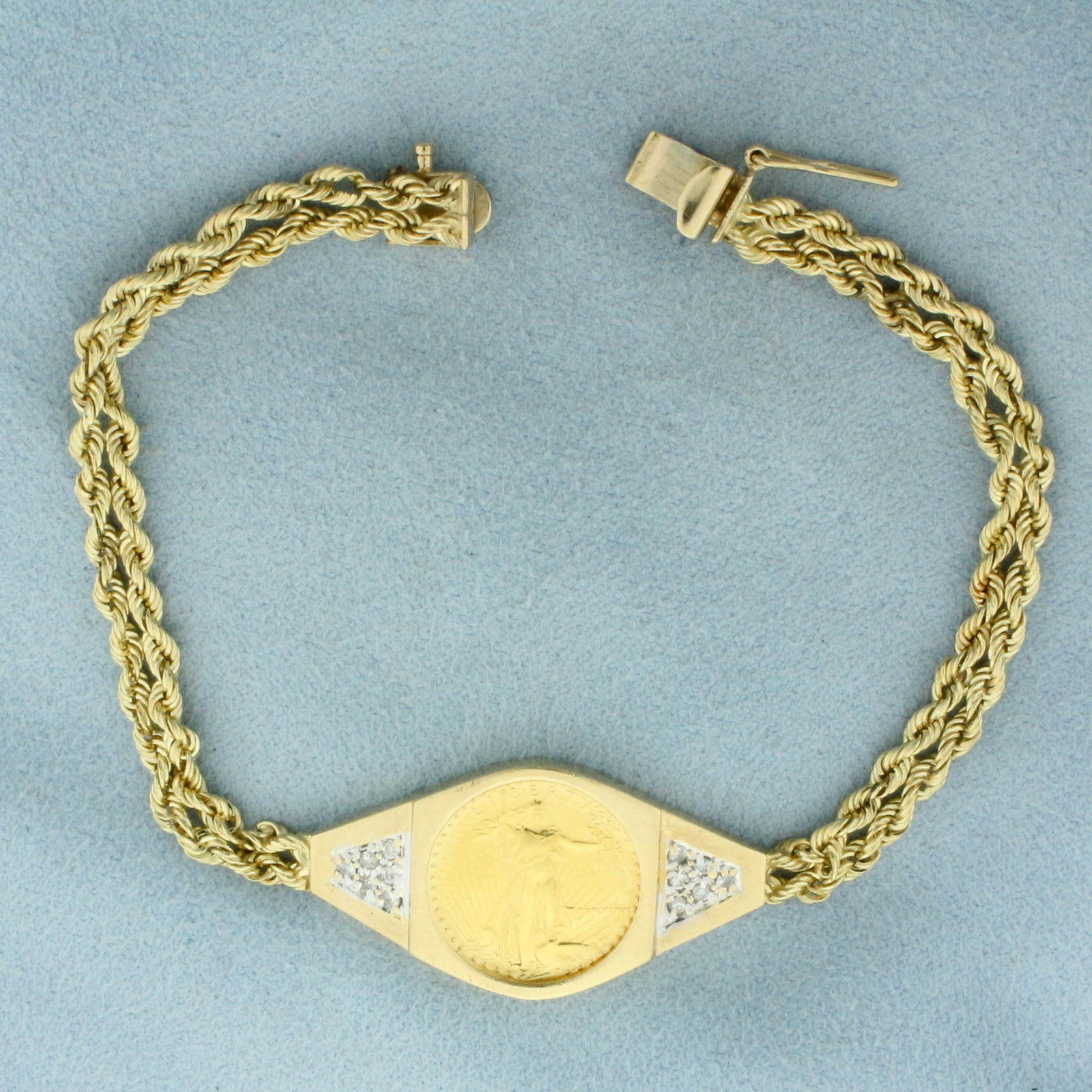 Gold Eagle Coin and Diamond Rope Bracelet in 14k Yellow Gold: In 14k Yellow Gold. Contains one 1/10 ounce Five Dollar Gold Eagle Coin. Also contains twelve .01ct high quality diamonds, SI clarity/H color. 7 1/8 inches long. 5/8 inch wide at center. Slide closure