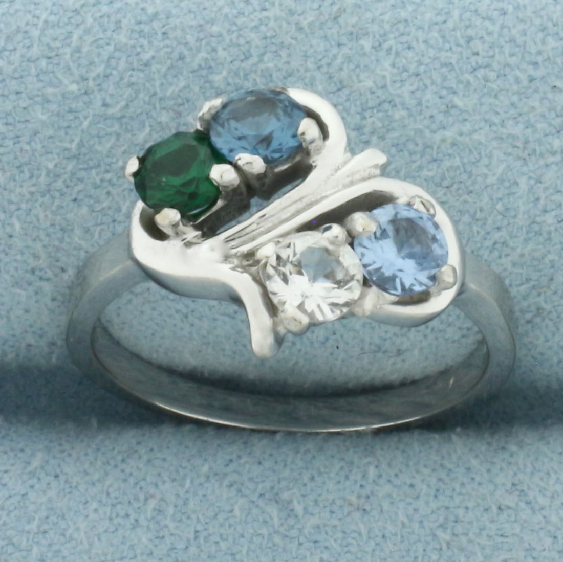 Rainbow Topaz Ring in 10k White Gold: In 10k White Gold. Contains four 4mm high quality Topaz gemstones with vibrant color and excellent clarity. 12mm wide at center. Size 7. 3.0g.