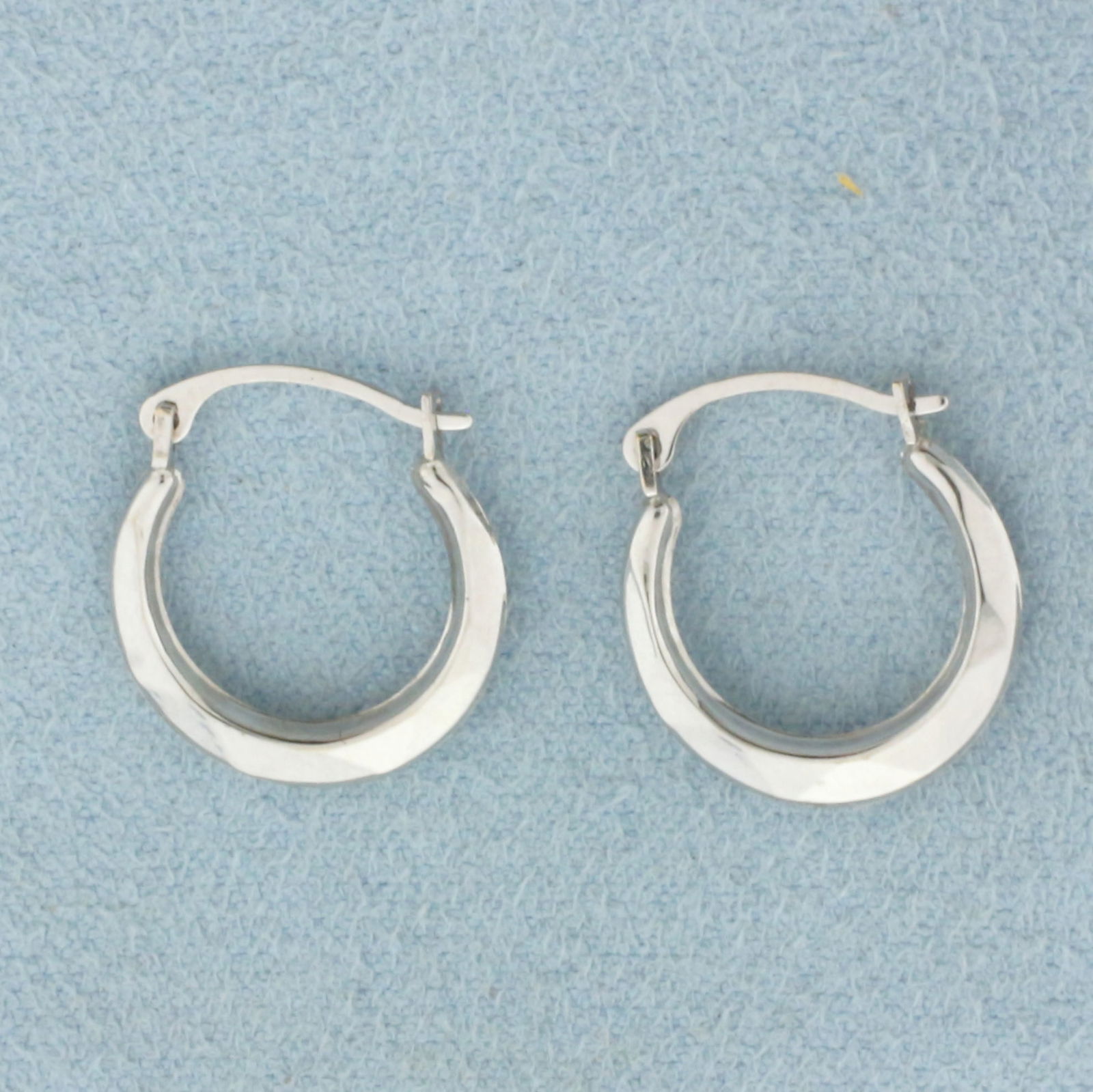 Hoop Earrings in 10k White Gold: In 10k White Gold. 5/8 inch diameter. 2.3mm wide. Hinged backs. 0.4g.