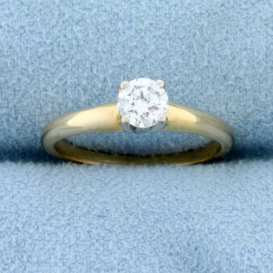 Solitaire Diamond Engagement Ring in 14K Yellow Gold: 14k Yellow Gold Shank with 14k White Gold Prongs. Contains a 1/3ct high quality round brilliant diamond, VS clarity/H color, excellent cut for lots of sparkle. Size 4 3/4. 2.1g.