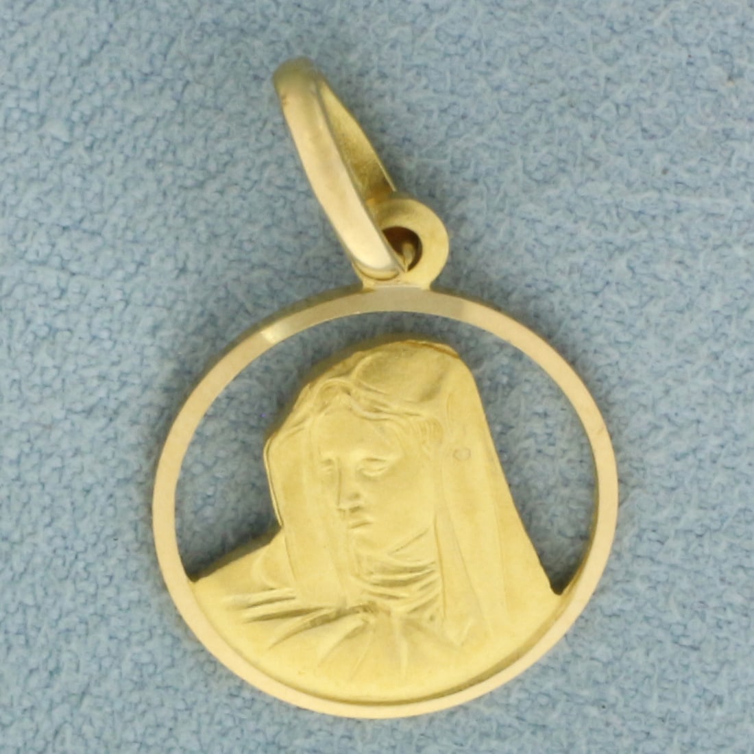 Virgin Mary Religious Medal Disc Pendant in 18k Yellow Gold: In 18k Yellow Gold. 7/8 inch long. 5/8 inch wide. 2.1g.
