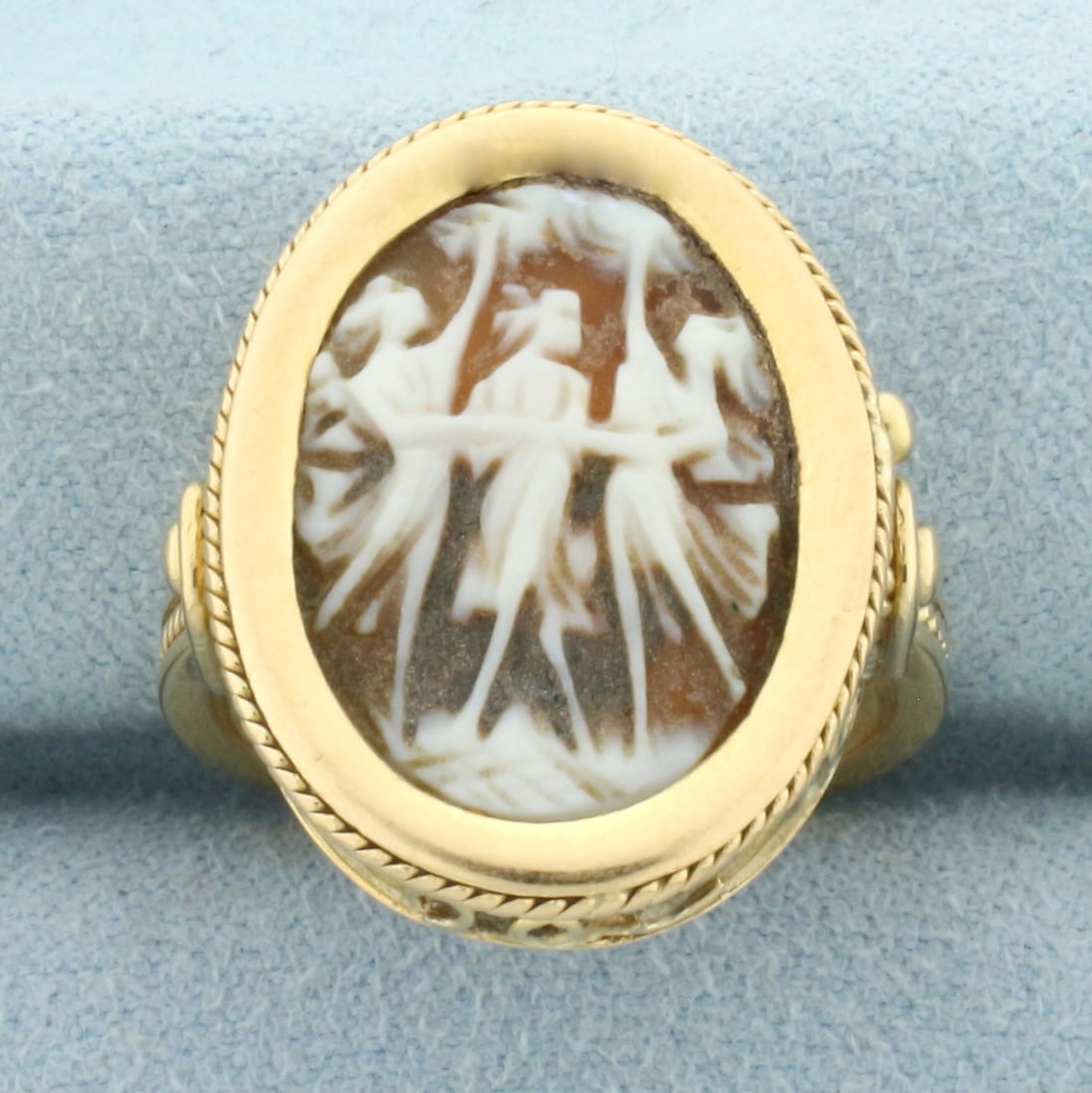 Three Graces Carved Shell Cameo Ring in 18k Yellow Gold: In 18k Yellow Gold. High quality carved three graces shell cameo. 23mm by 18mm face of ring. Size 7. 8.1g.