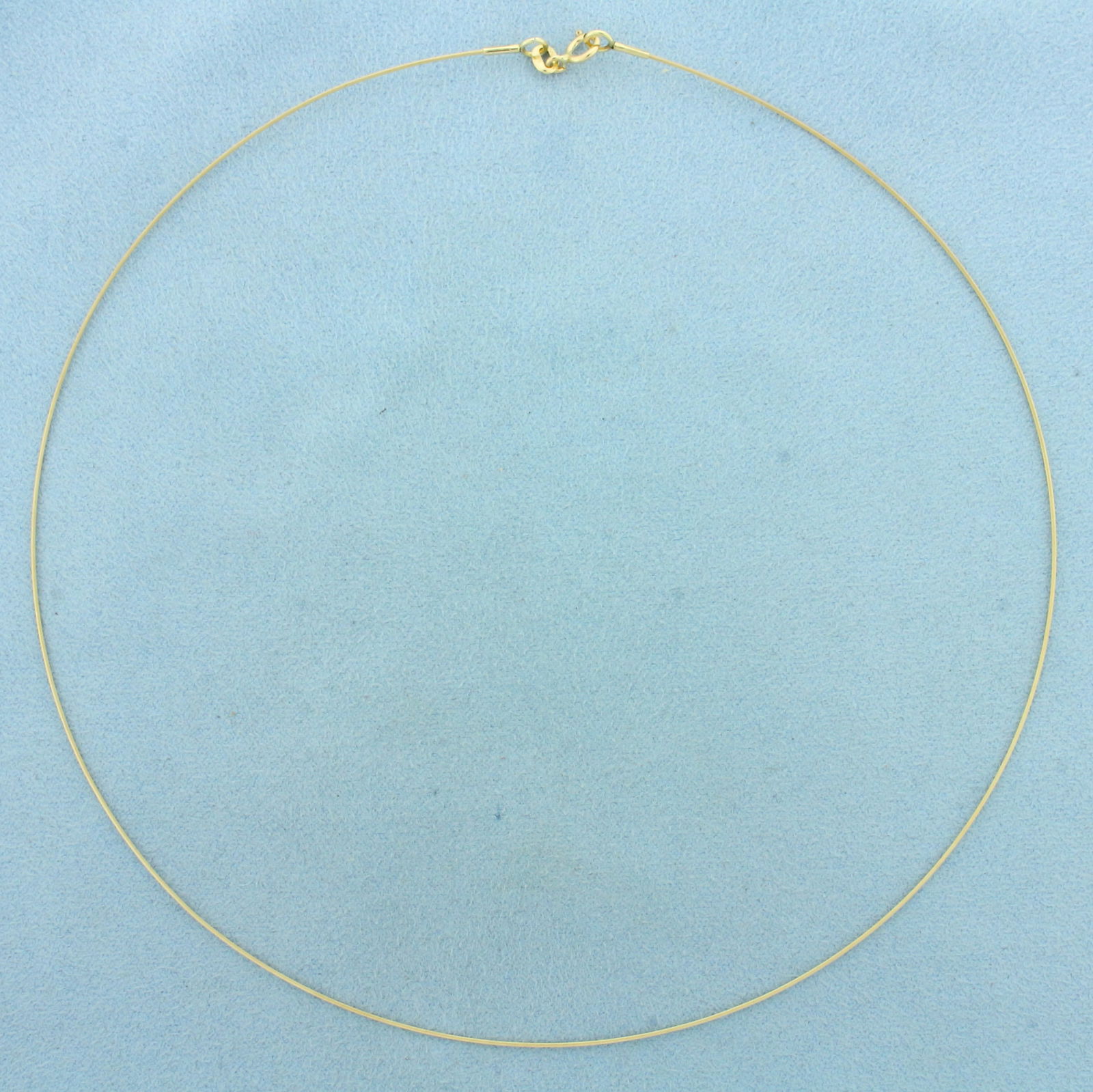 Wire Choker Necklace in 14k Yellow Gold: In 14k Yellow Gold. 16 inches long. 0.6mm thick. Spring clasp. 1.3g.