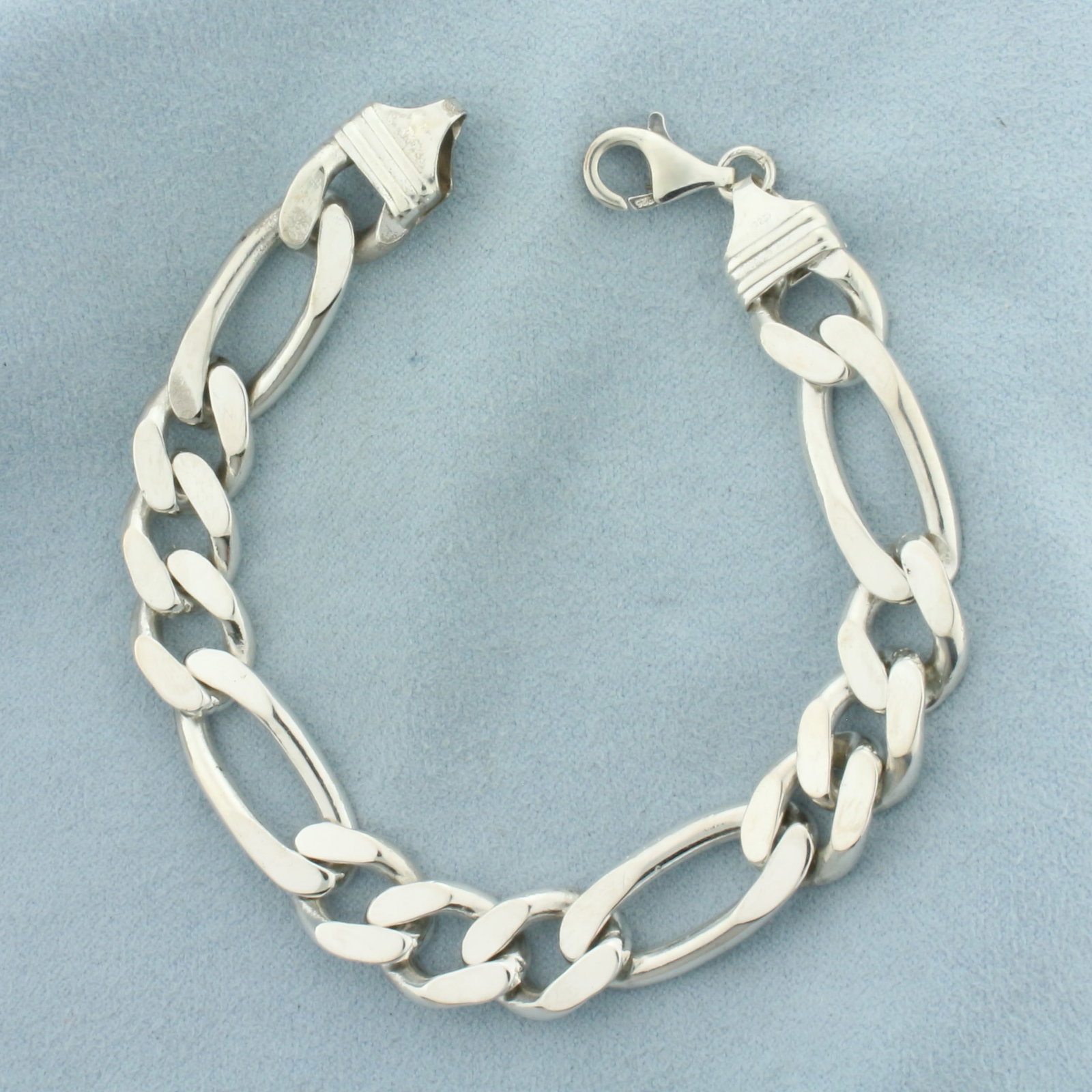 Figaro Link Chain Bracelet in Sterling Silver: In .925 Sterling Silver. 8 inches long. 11mm wide. Lobster clasp. 36.1g.