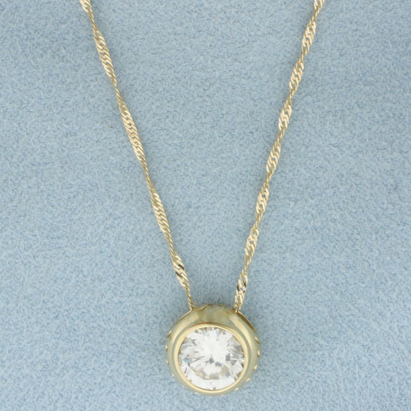 Bezel Set CZ Necklace in 14k Yellow Gold: In 14k Yellow Gold. Contains one 8mm high quality Cubic Zirconia, approximately 2.5ct, with excellent cut and color for added brilliance. Twisting curb link chain is 18 inches long chain. 1mm wide. Sp