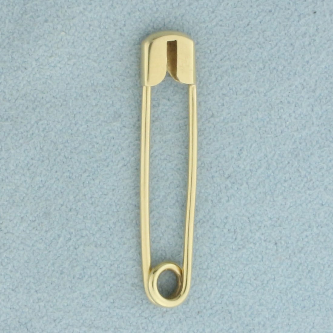 Safety Pin in 14k Yellow Gold: In 14k Yellow Gold. 1 1/8 inch long. 1/4 inch wide. Can attach charms. 1.1g.