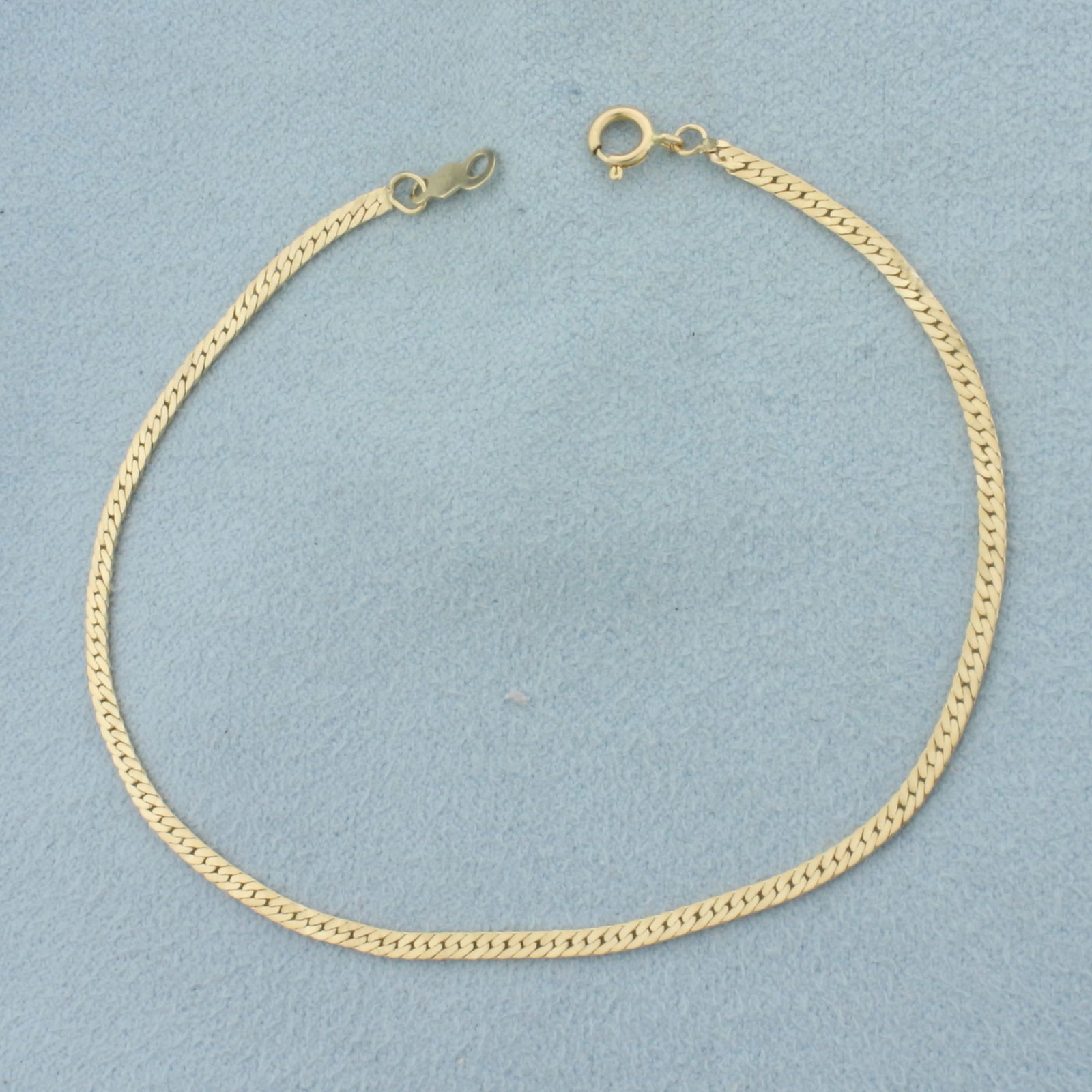 Herringbone Link Bracelet in 14k Yellow Gold: In 14k Yellow Gold. 7 1/8 inches long. 1.7mm wide. Spring clasp. 1.4g.
