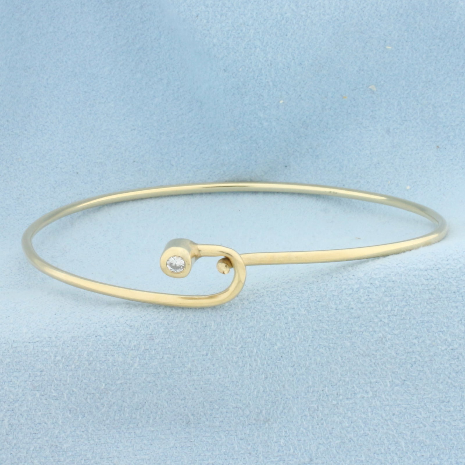 Diamond Bangle Bracelet in 14k Yellow Gold: In 14k Yellow Gold. Contains one .1ct high quality diamond, SI2 clarity/H color. Interior dimensions: 2 3/8 x 2 inches. 5.8g.