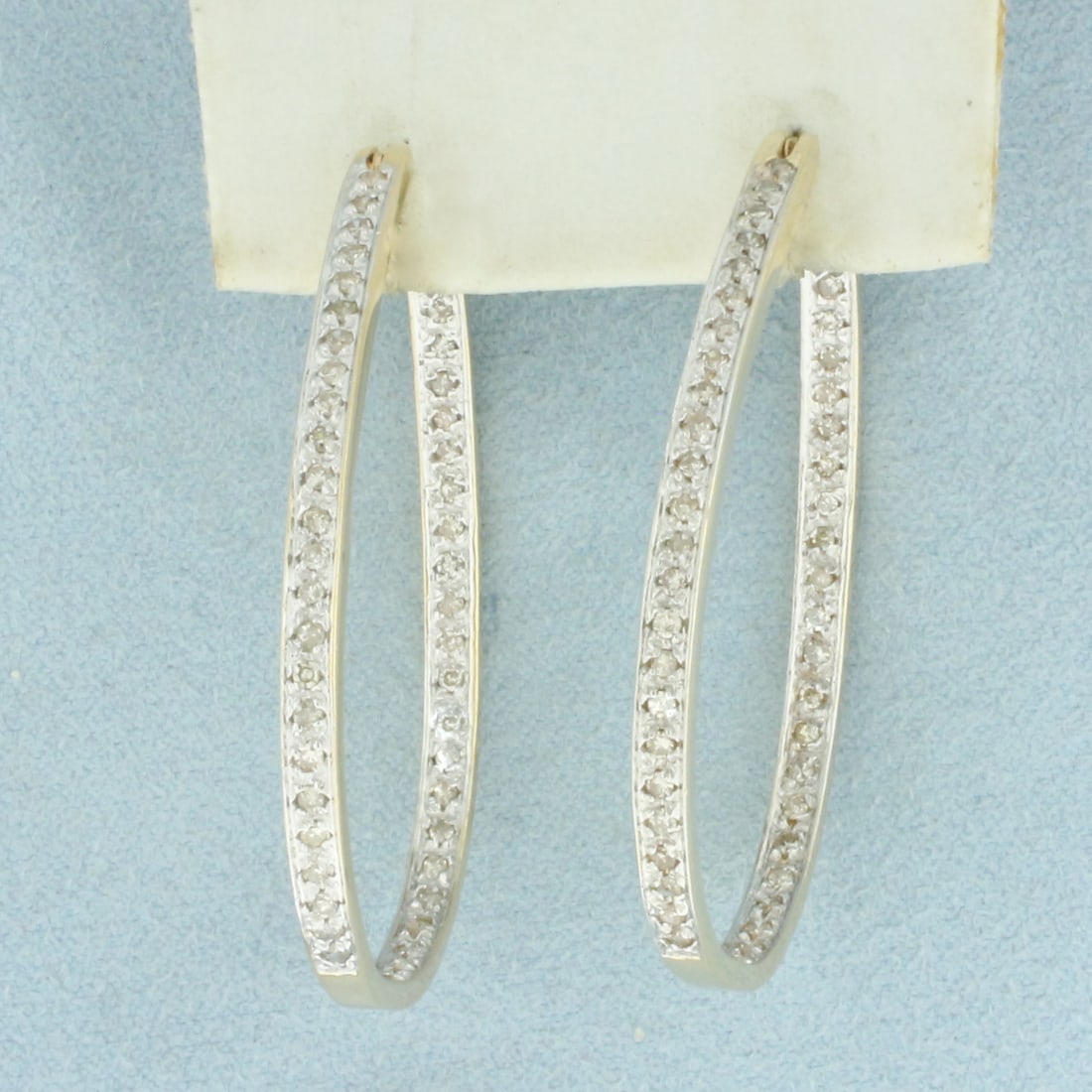 Large Diamond Inside Out Hoop Earrings in 14K Yellow Gold: In 14k yellow gold. Contains ninety six high quality diamonds, 1ct TW, I color/I clarity. Measures 1.75" x 1.25". Leverbacks. 10.7g.