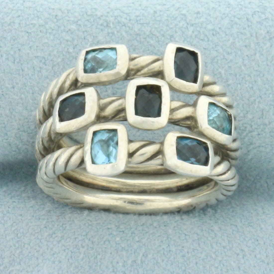 David Yurman Confetti 3 Row Cable Ring in Sterling Silver: In .925 Sterling Silver. Contains seven high quality checkerboard cushion natural London Blue Topaz and Blue Topaz gemstones with vibrant color. 14mm wide at widest. Size 5.5.