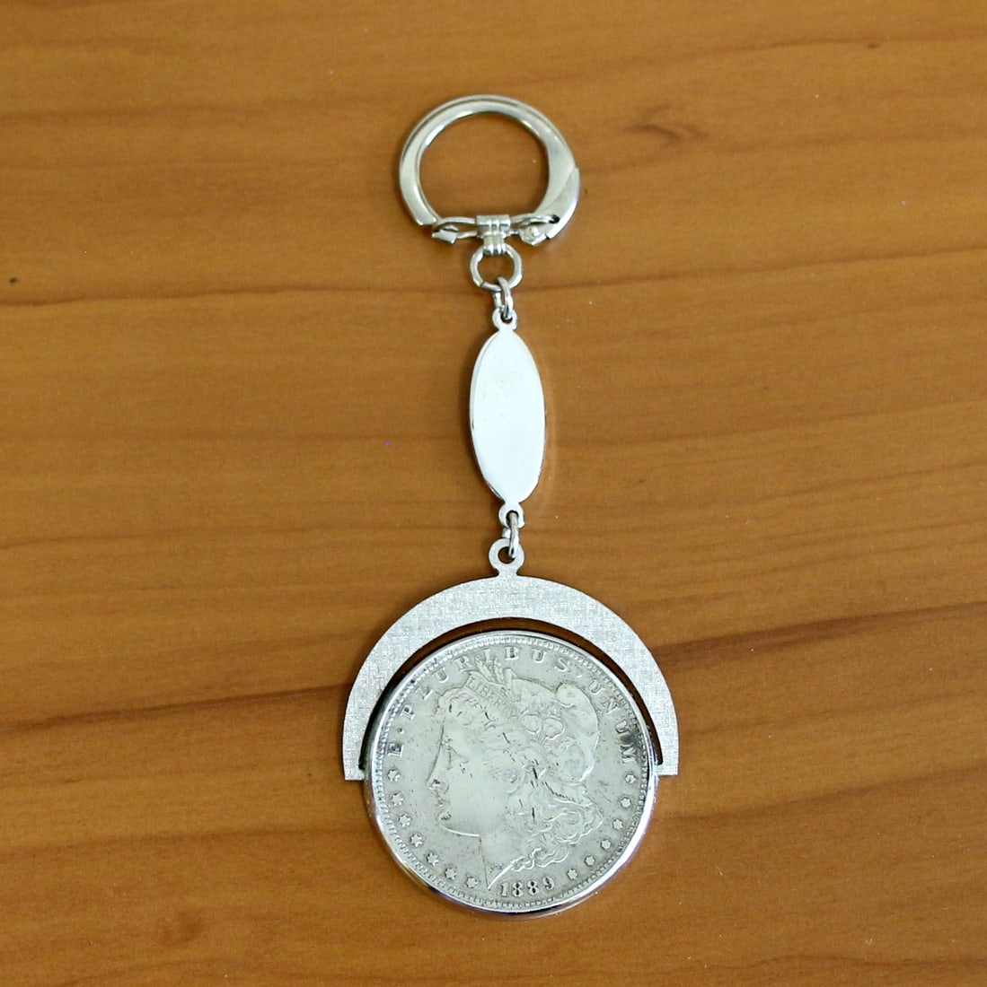 1889 Morgan Silver Dollar Keychain: Contains one 1889 Morgan Silver Dollar. Includes original box.