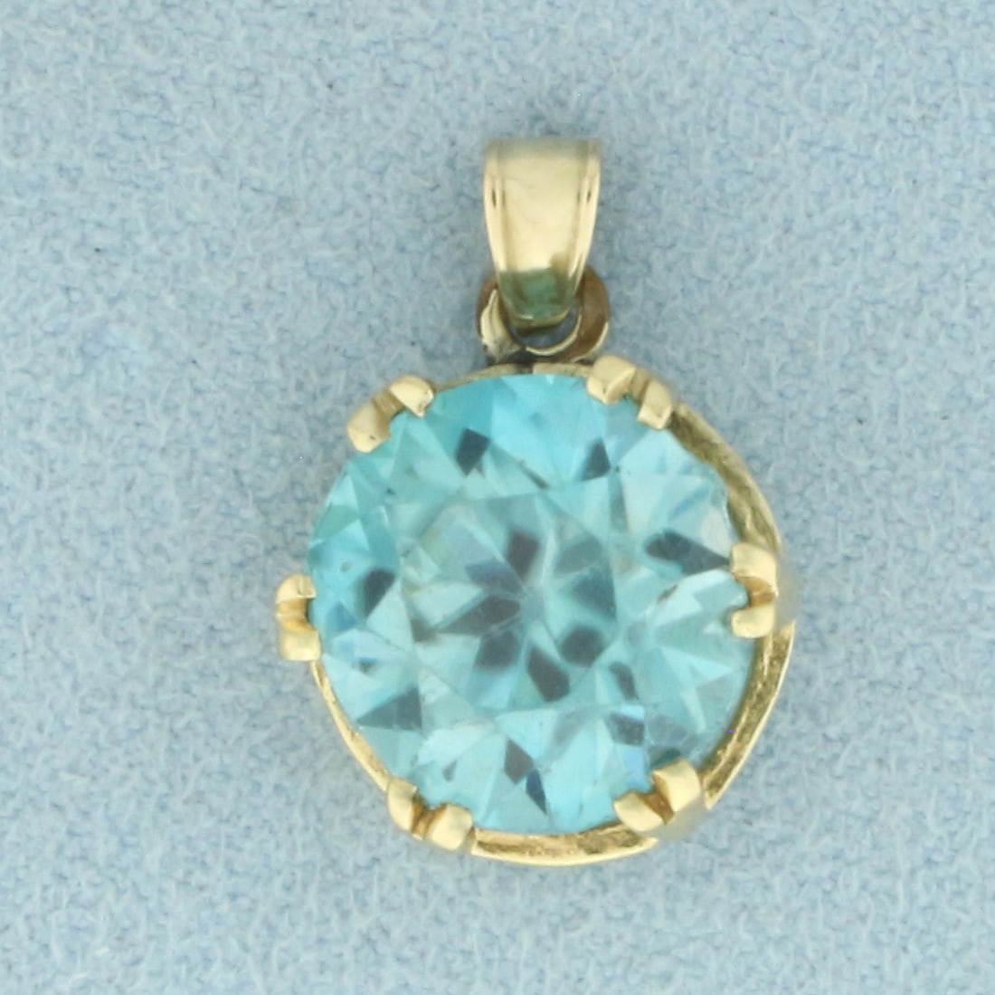 Vintage Blue Spinel Pendant in 10k Yellow Gold: In 10k Yellow Gold. Contains one 7ct natural Blue Spinel gemstone, with electric blue color and excellent clarity. Some chipping on girdle, indicative of age, does not affect beauty of stone. 3/4 inch