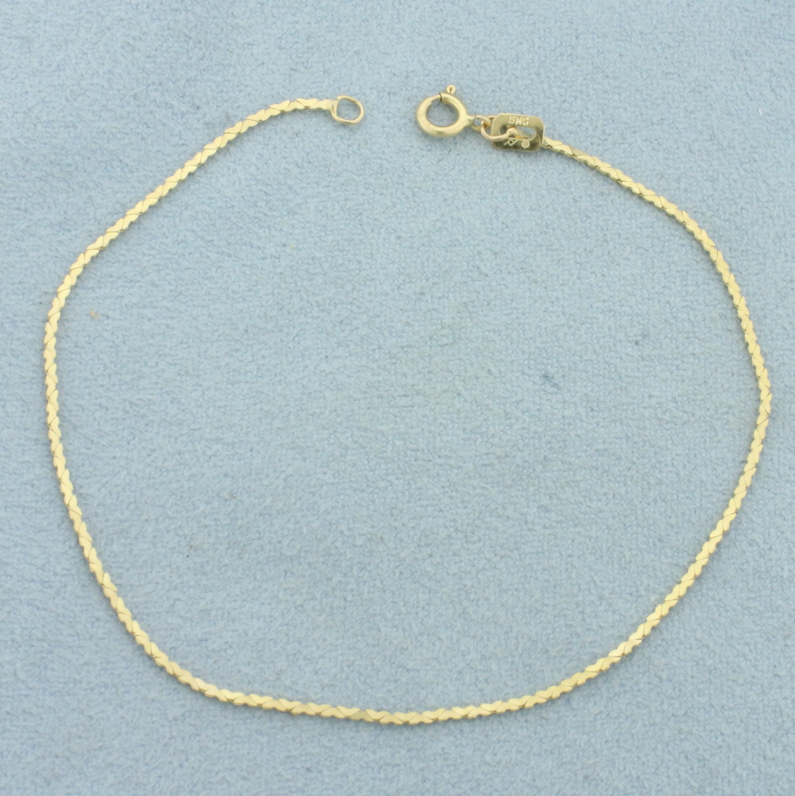 Italian Heart Link Bracelet in 14k Yellow Gold: In 14k Yellow Gold. 6 7/8 inches long. 1mm wide. Italian made. Spring clasp. .7g.