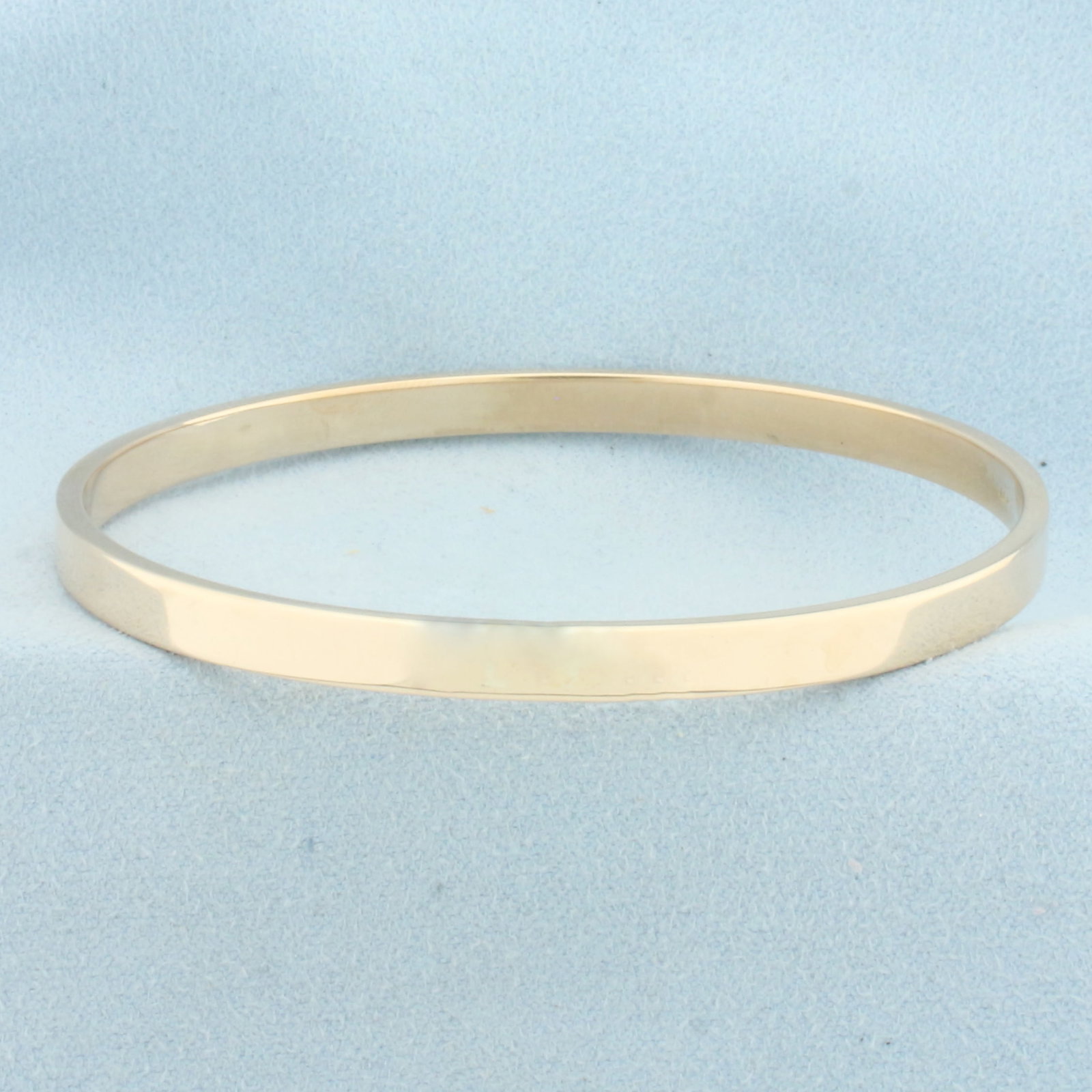 Oval Bangle Bracelet in 10k Yellow Gold: In 10k Yellow Gold. Interior dimensions: 2 5/8 by 2 1/4 inches. 5mm wide. 7.0g.