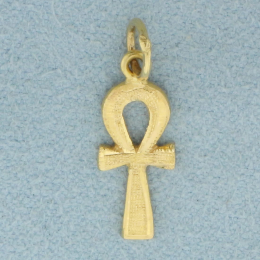 Ankh Pendant or Charm in 18k Yellow Gold: In 18k Yellow Gold. 7/8 inch long (including jump ring). 1/4 inch wide. .9g.