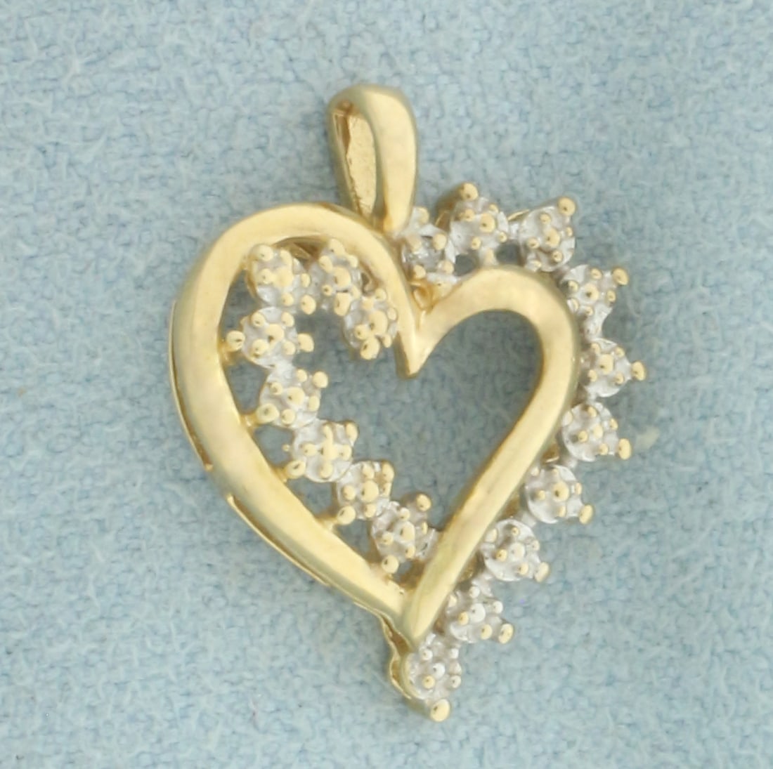 Diamond Heart Pendant in 10k Yellow and White Gold: In 10k Yellow and White Gold. Contains one high quality 1/2pt diamond. 3/4 inch long. 1/2 inch wide. 1.5g.