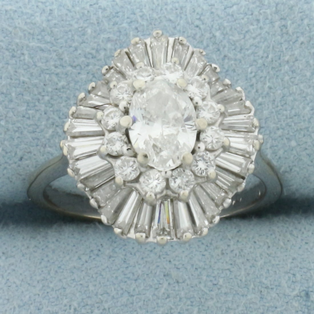 Diamond Ballerina Ring in 14k White Gold: In 14k White Gold. Contains one 2/3ct high quality oval diamond, SI clarity/G color, great cut for added brillance. Also contains twelve round, and thirty baguette high quality diamonds, 1 1/3ct TW, o