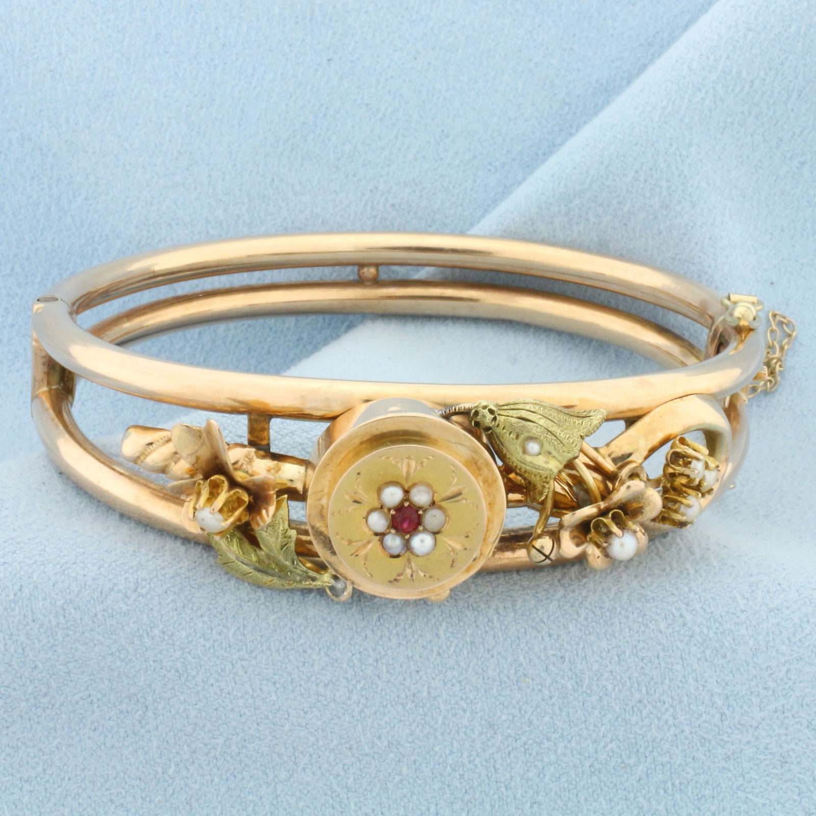 Hinged Antique Ruby and Pearl Bangle Bracelet in 14k Rose and Green Gold: In 14k Rose and Green Gold. Contains one high quality 2mm natural ruby with rich color. Also contains eleven high quality seed pearls with high luster. Interior dimensions: 2 1/4 by 2 inches. 16.7mm w