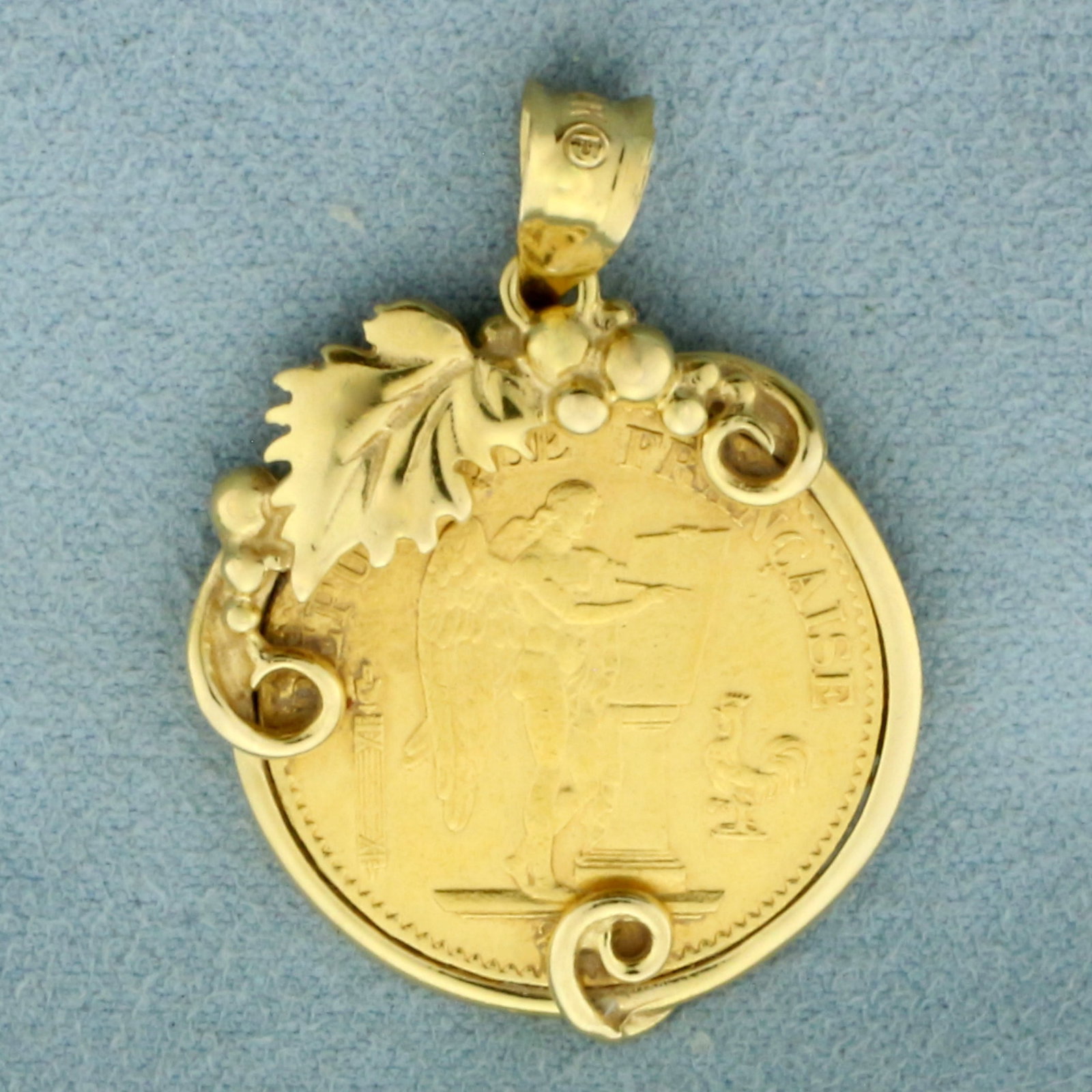 1875 20 Francs Angel Gold Coin Pendant in 14k Yellow Gold Bezel: In 14k Yellow Gold Bezel. Contains one 1875 20 Francs 90% pure gold coin. 1 3/8 inch long including bale. 1 inch wide. 9.7g.
