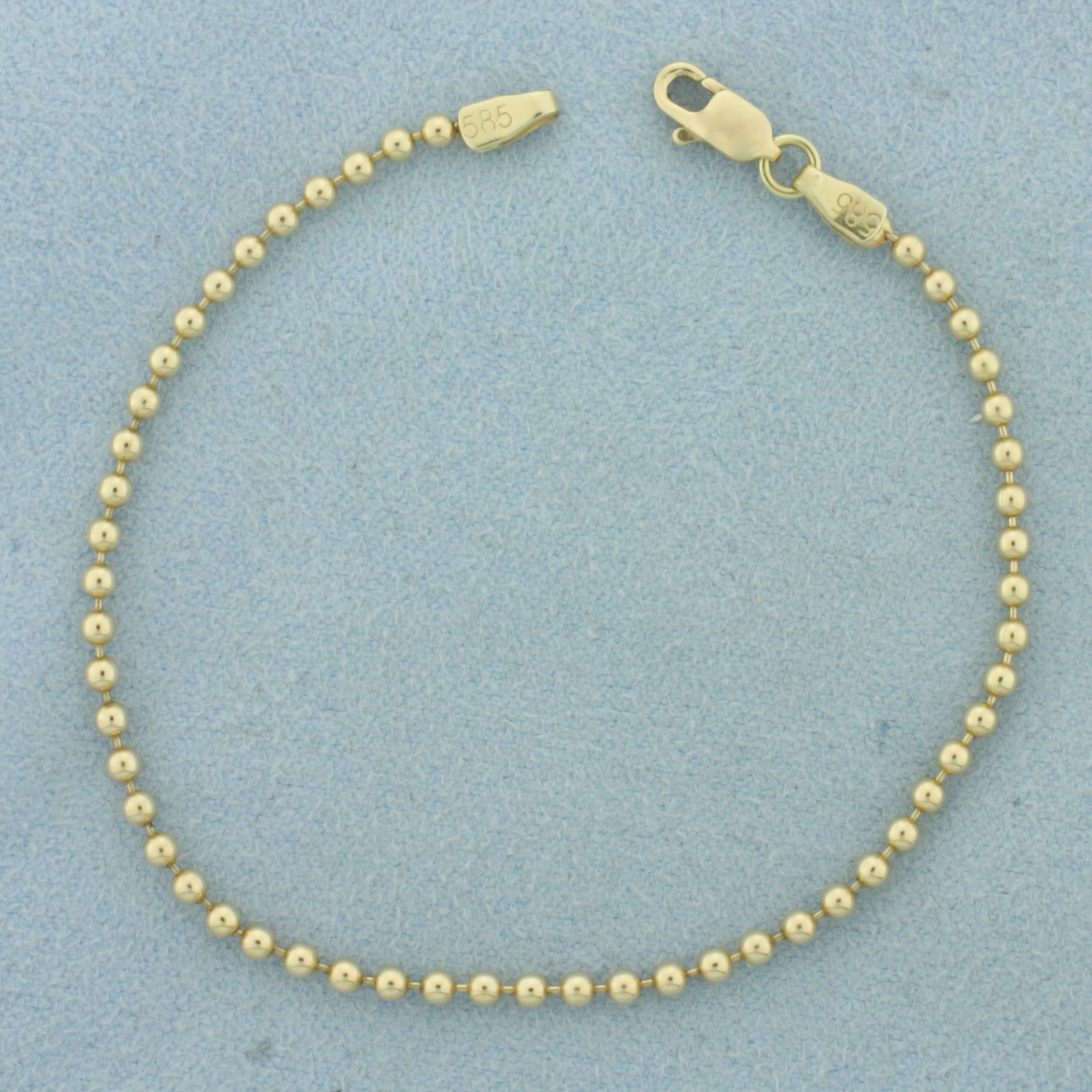 Ball Bead Bracelet in 14k Yellow Gold: In 14k Yellow Gold. 6 1/8 inches long. 2mm wide. Lobster clasp. 2.5g.
