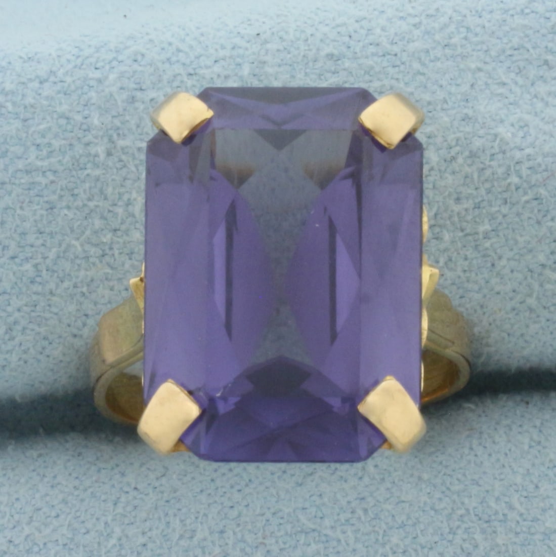 Color Changing Spinel Solitaire Ring in 18k Yellow Gold: In 18k Yellow Gold. Contains one 18x13mm high quality Color Changing Spinel gemstone, approximately 14ct, with dramatic color change from purple to pink. Size 7.25. 7.2g.