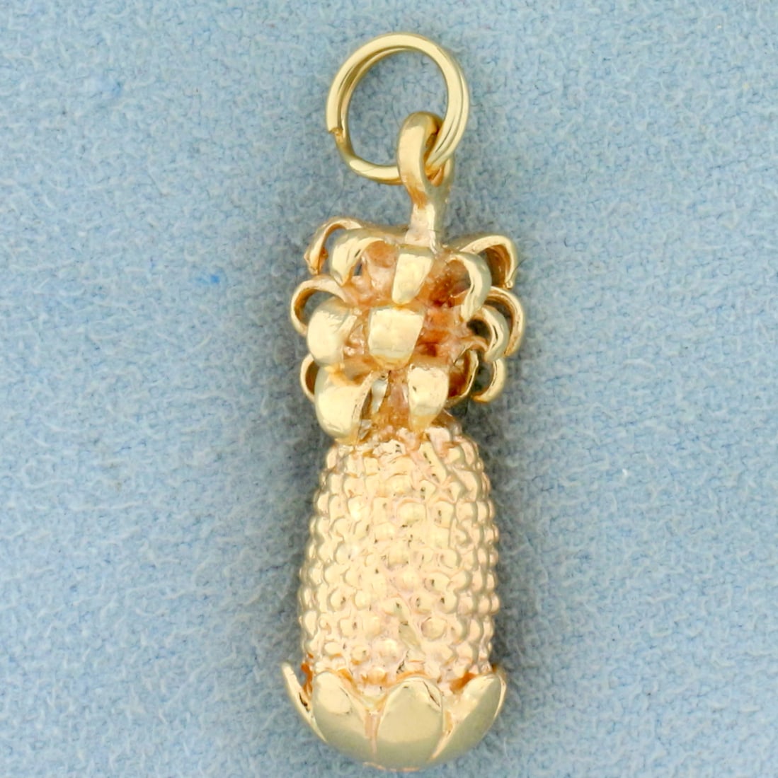 Pineapple Pendant or Charm in Solid 14K Yellow Gold: In 14K Yellow Gold. 1 1/4 inches long including jump ring. 3/8 inch wide. Solid gold, not hollow. 5.9g