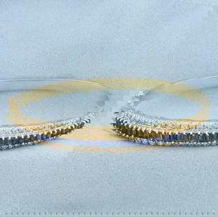Sapphire and Diamond Hinged Bangle Bracelet in 14k Yellow Gold: In 14k Yellow Gold. Contains thirty-eight high AAA quality emerald cut natural Sapphire gemstones, approximately 3ct TW, with intense color and excellent clarity. Also contains sixty-two .01ct high qu